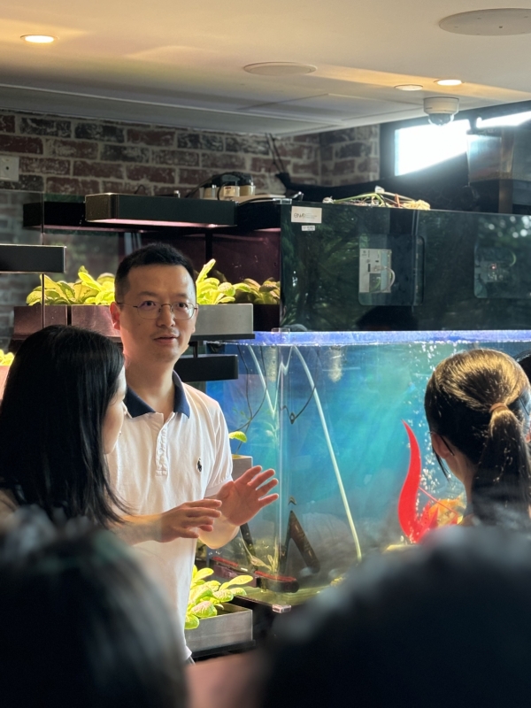Professor Zhongming Lu introduced an aquaponics system integrating aquaculture and hydroponics, showcasing sustainable food production to support local self-sufficiency.